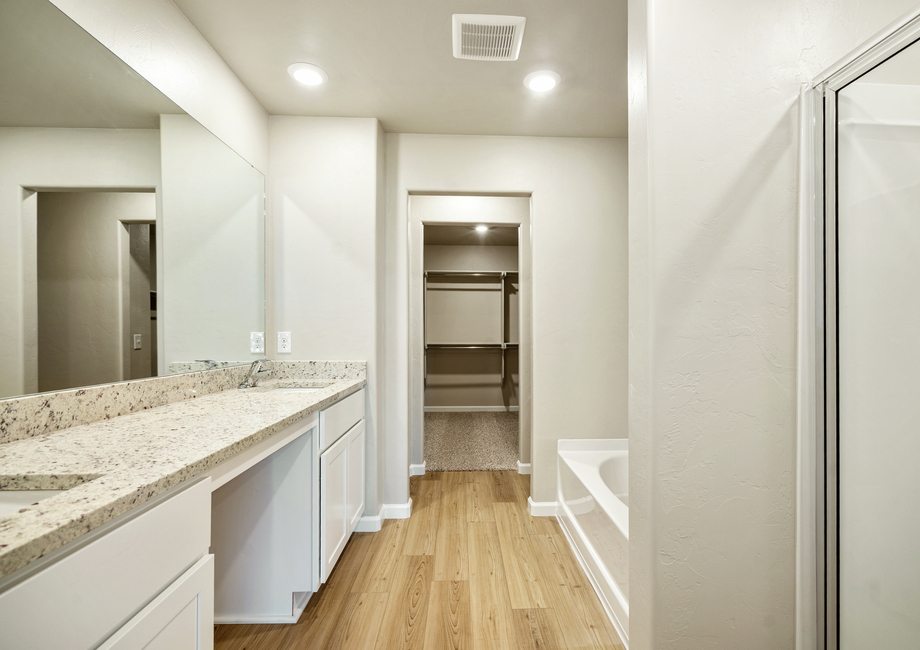 This bathroom features a built in vanity with dual sinks.