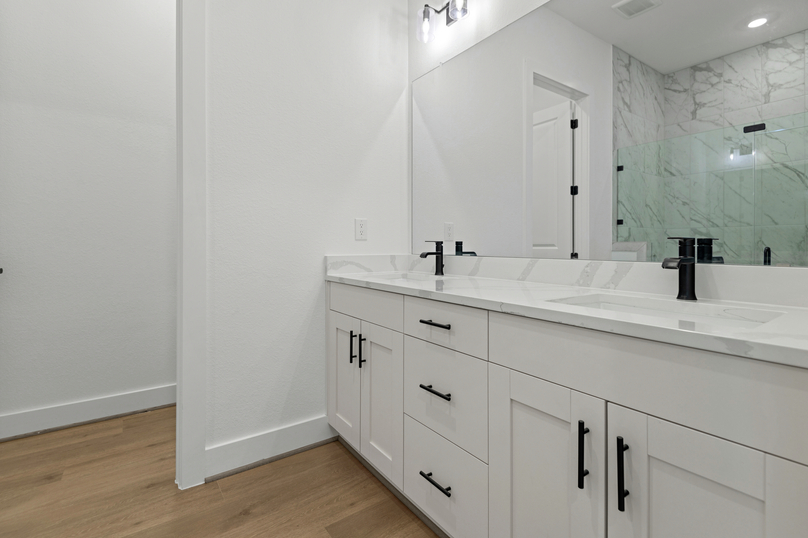 The primary bath is home to ample storage.