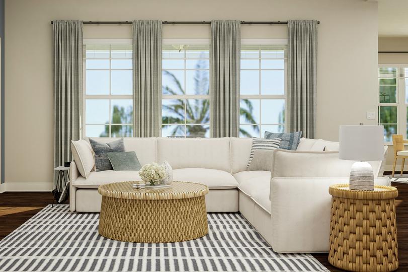 Rendering of living room showing a beige
  media cabinet and tv on left, a white sectional couch and coffee table in
  front of large windows center, and the corner of the dining room on right
  with dark wood look flooring throughout.