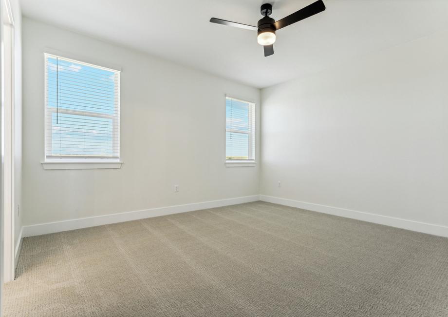 The master bedroom is a spacious and has two large windows that let in great, natural light.