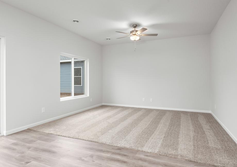 The family room is spacious with a ceiling fan.