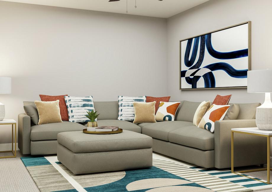 Rendering showing the cozy second floor
  loft with comfortable grey sectional, ottoman and geometric rug. 2 white and
  gold side tables flank the couch.