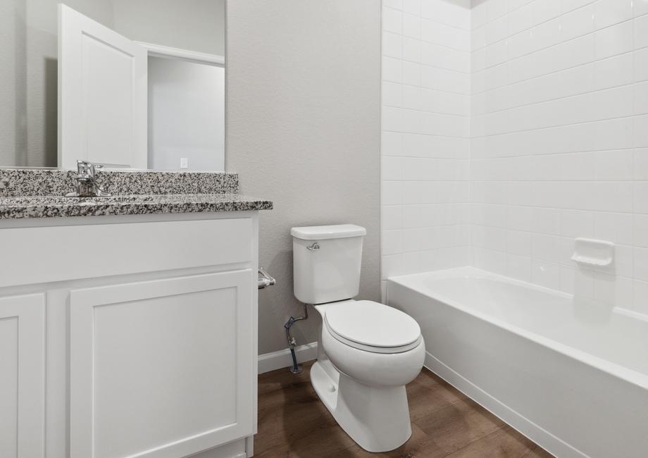 Secondary bathroom has plenty of counterspace and a shower-tub combo.