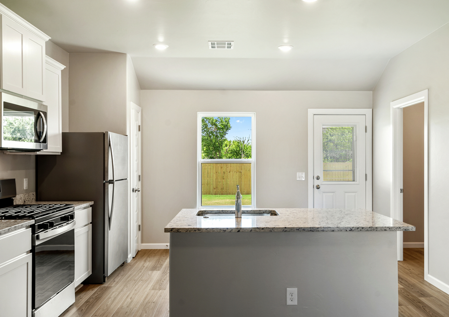 A large window fills the kitchen with natural light creating a warm space.