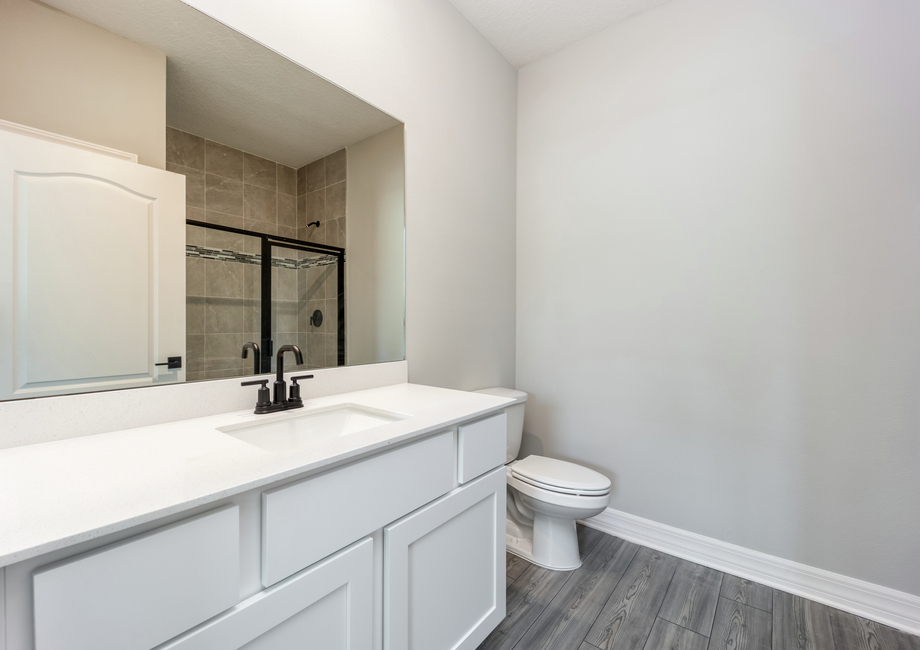 The master bathroom has a large vanity and step-in shower