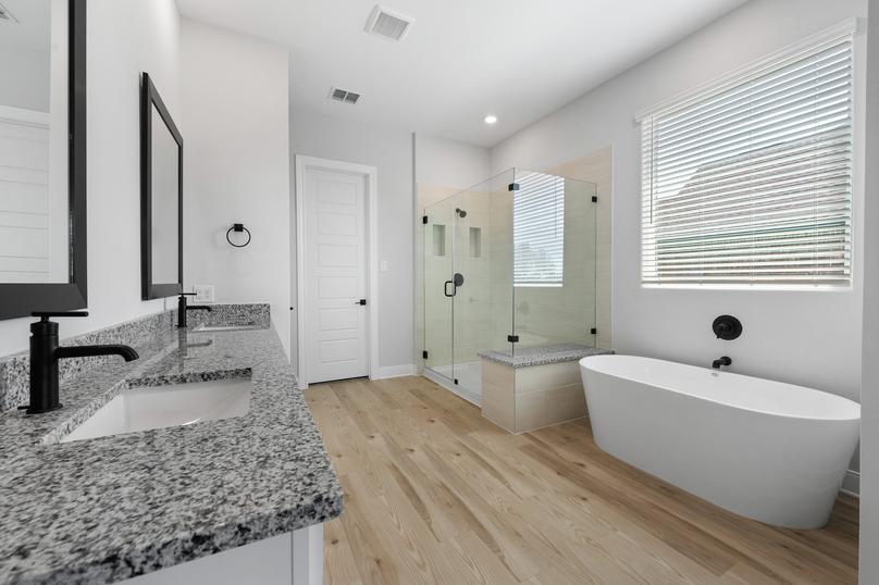 The master bath has a large vanity and a walk-in shower.