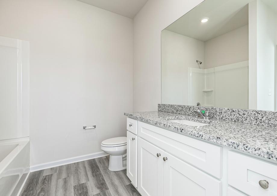 The gorgeous master bathroom offers plenty of space to get ready in the mornings