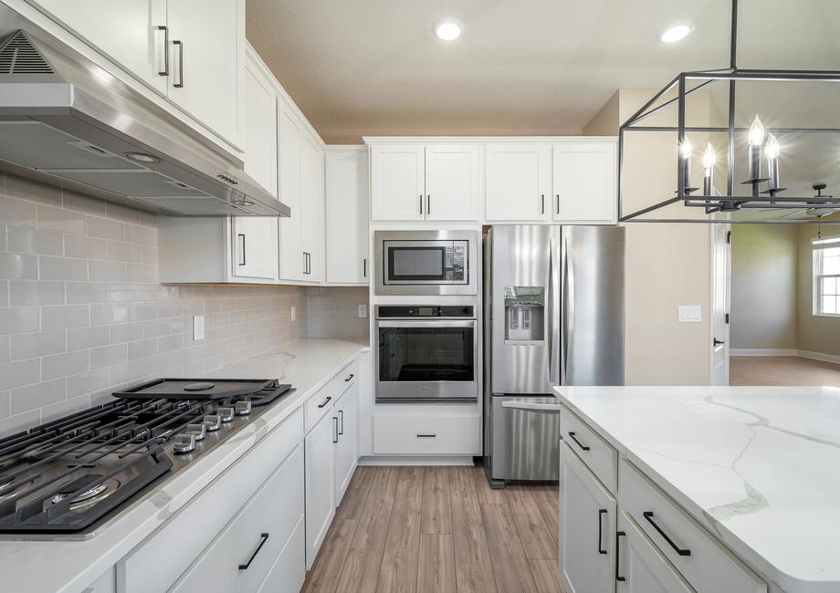 The kitchen includes stainless steel appliances.