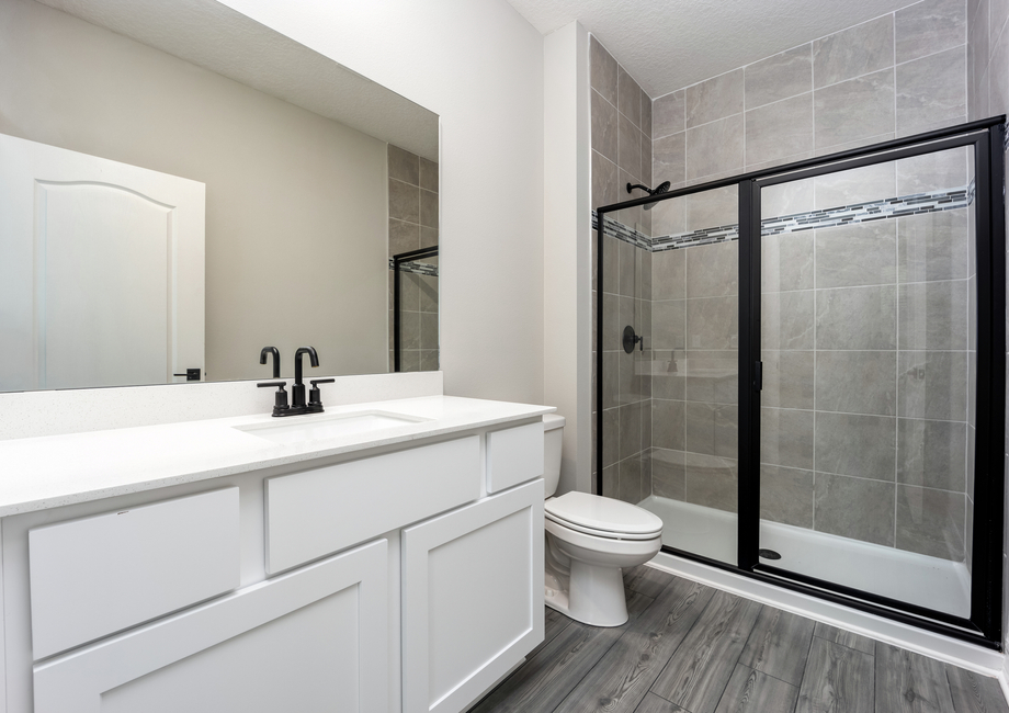 The master bathroom has a large vanity and a step-in shower