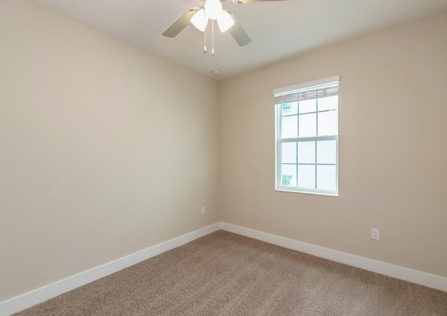 Windows let in plenty of light to this secondary bedroom.