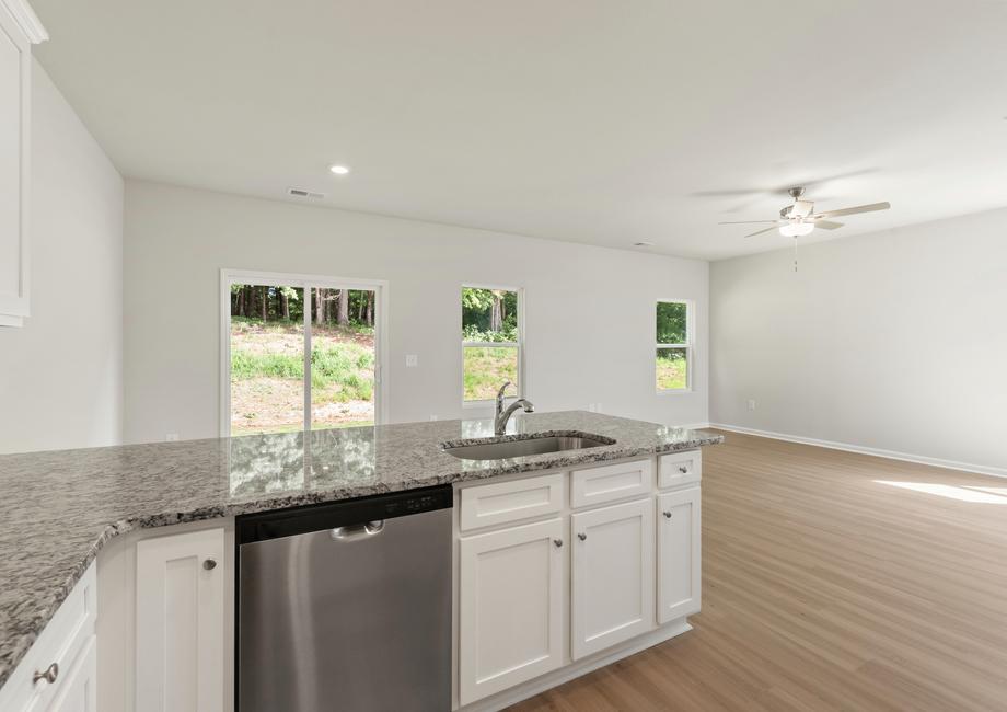 Open floor plan with a kitchen, dining area and living room.