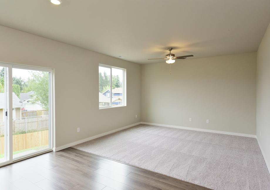 The family room is spacious and has a ceiling fan.