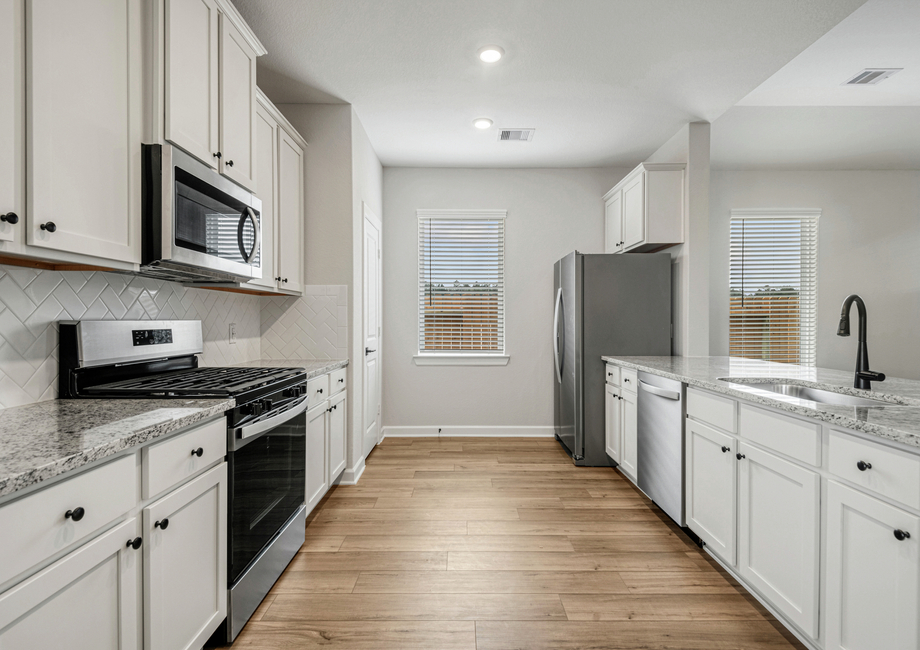 A window in the kitchen overlooks the side yard