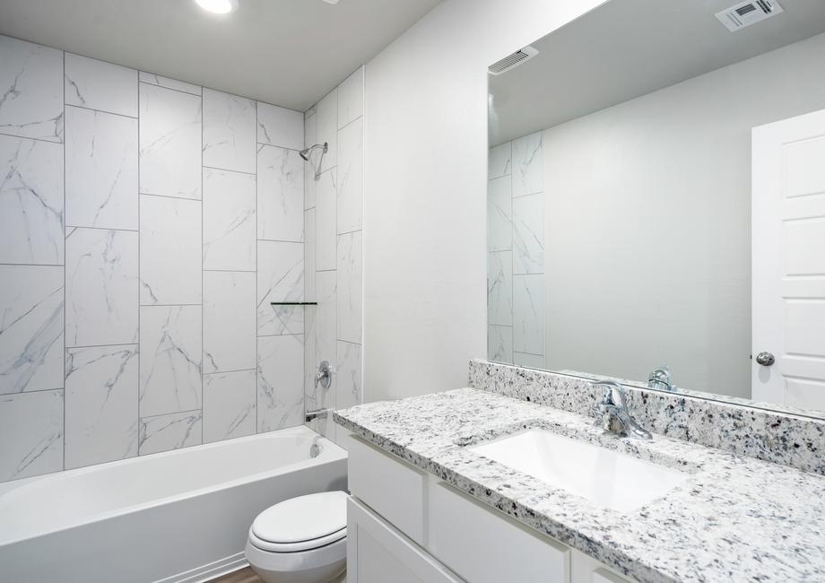 The secondary bathroom of the Coastal has a large shower-tub combo.