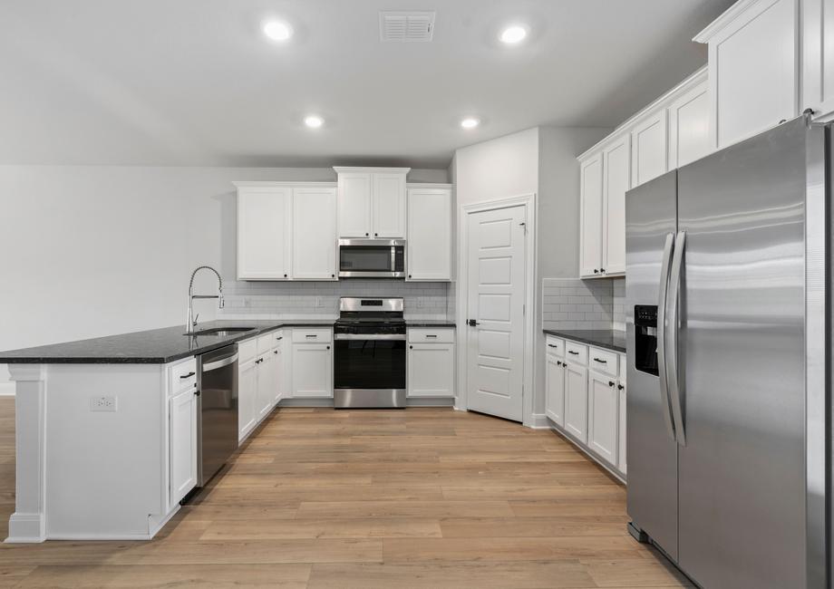 Upgraded kitchen with stainless steel appliances and granite countertops.