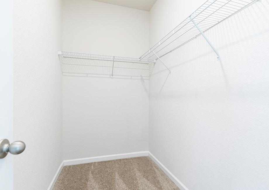 The walk in closet is spacious with shelving included