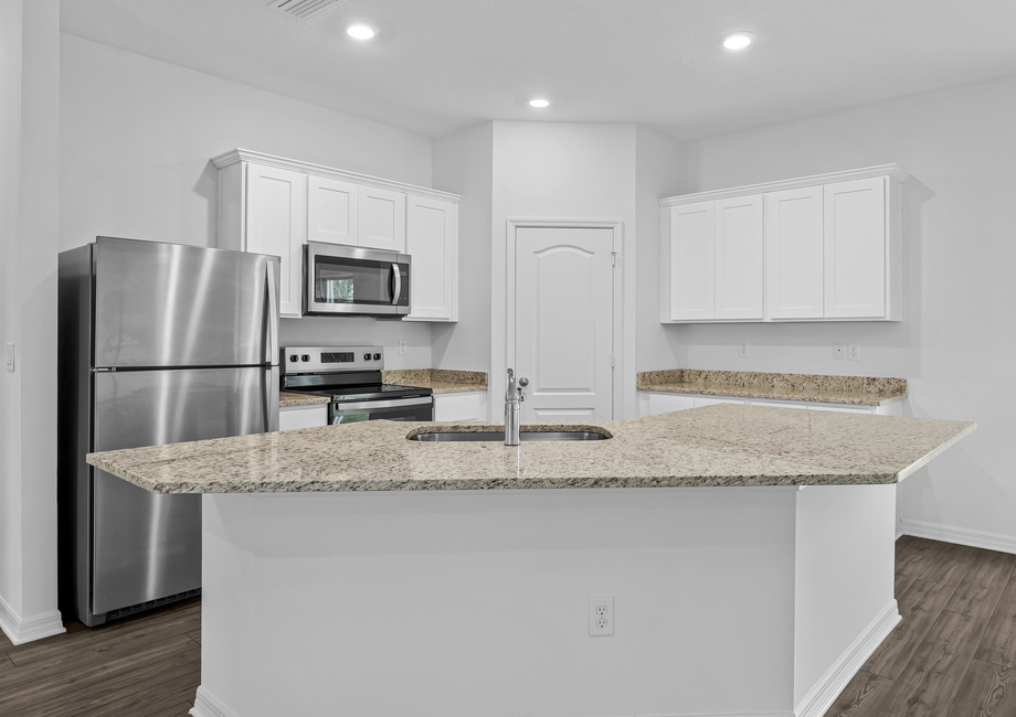 White cabinets and granite countertops in the kitchen