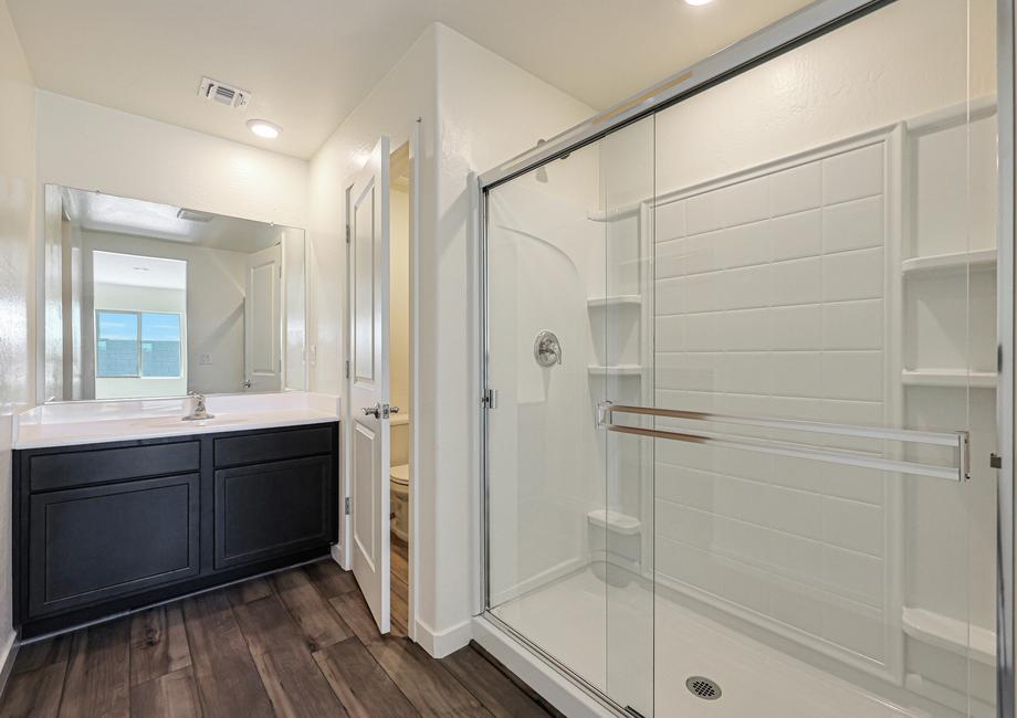 The master bath has a spacious, glass-enclosed shower.