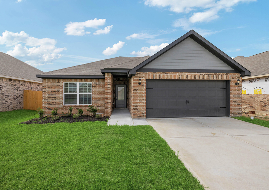 Exterior photo of the two-car garage Birkes plan with brick 