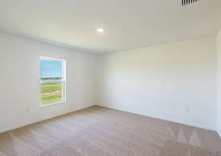 The guest bedroom is spacious and has plenty of natural light