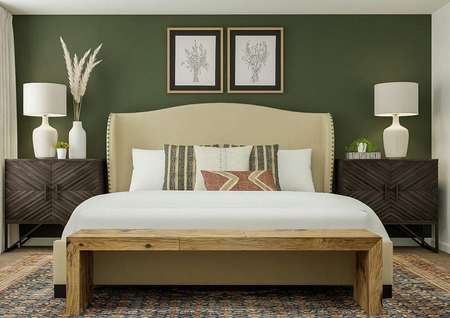 Rendering of the spacious master suite in
  the York, which shows a large bed with a wooden bench at the foot of it
  nestled between two large nightstands. 
