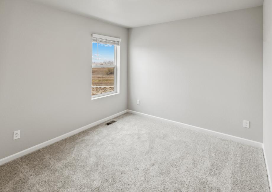 Guest bedroom with a window and closet with sliding doors.