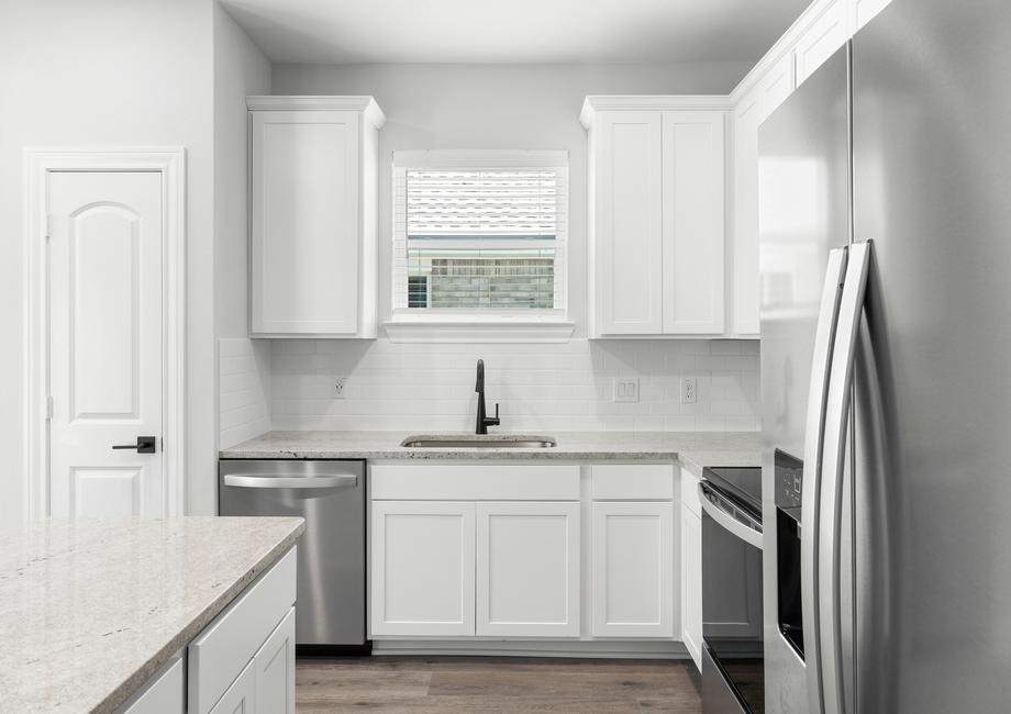 The kitchen of the Blanco has white wood cabinetry.