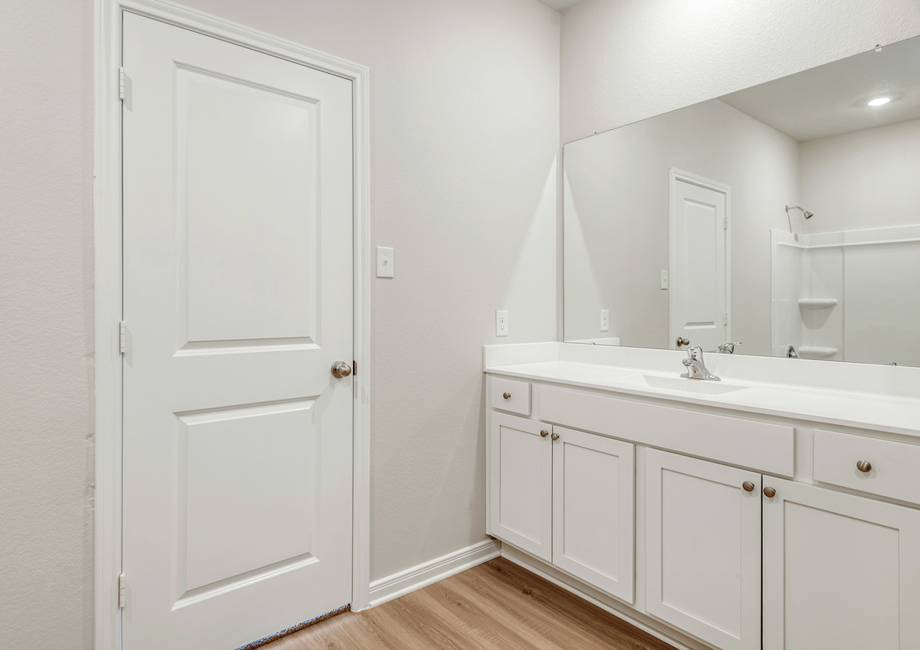 The master bathroom features a spacious vanity