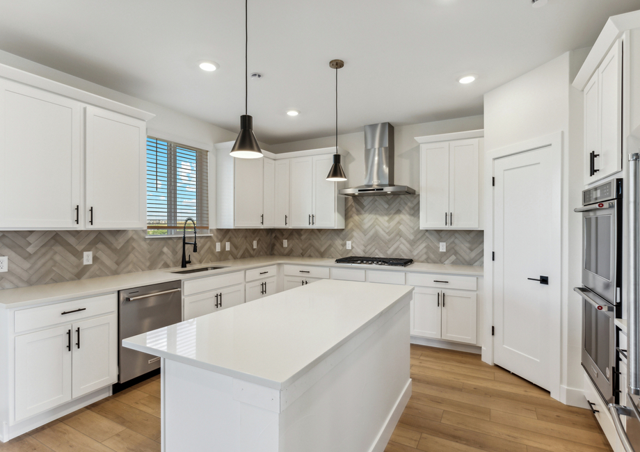 The gorgeous kitchen has beautiful quartz countertops.