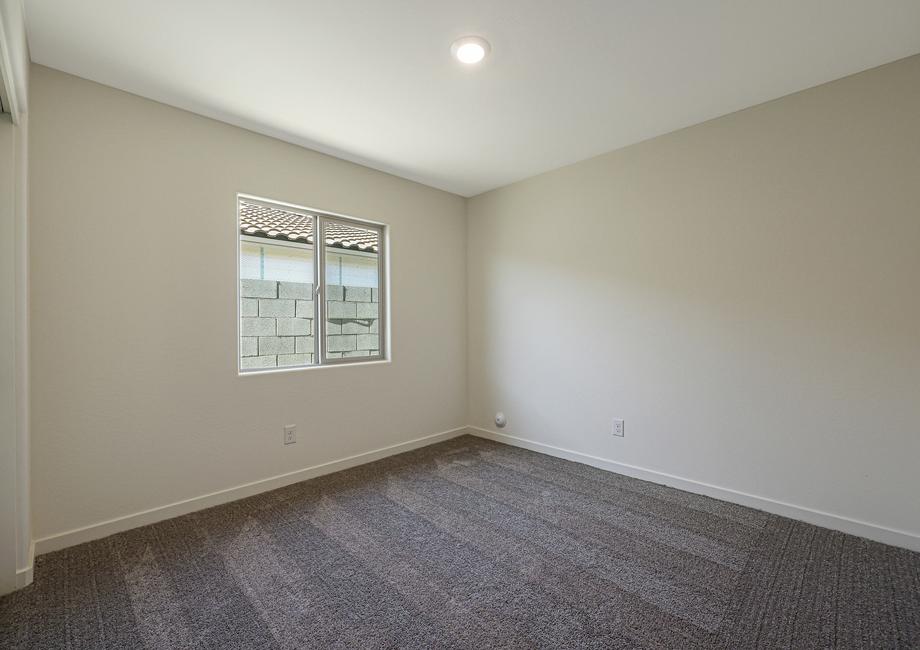 Windows let in plenty of light to this secondary bedroom.