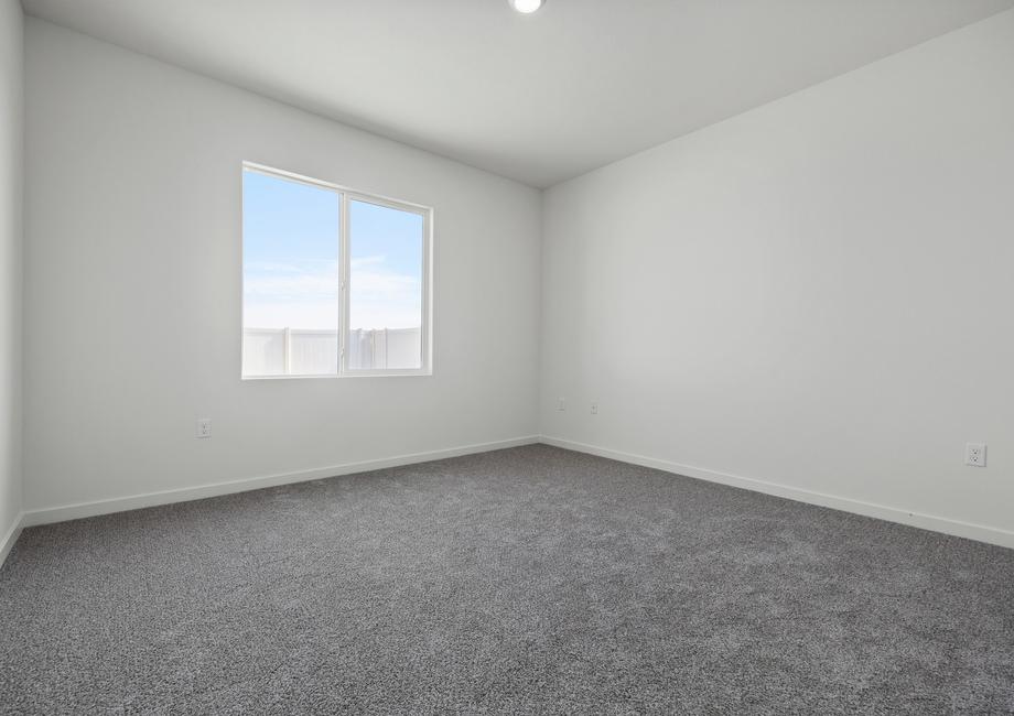 The master bedroom is spacious with a large window.