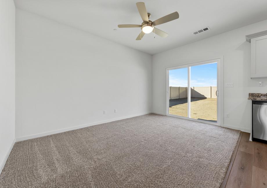 The family room is spacious with ceiling fan.