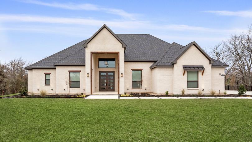 The Timberline II is a beautiful, one-story brick home with wood accents.