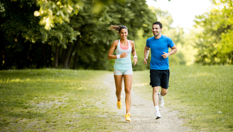 Couple running in park.