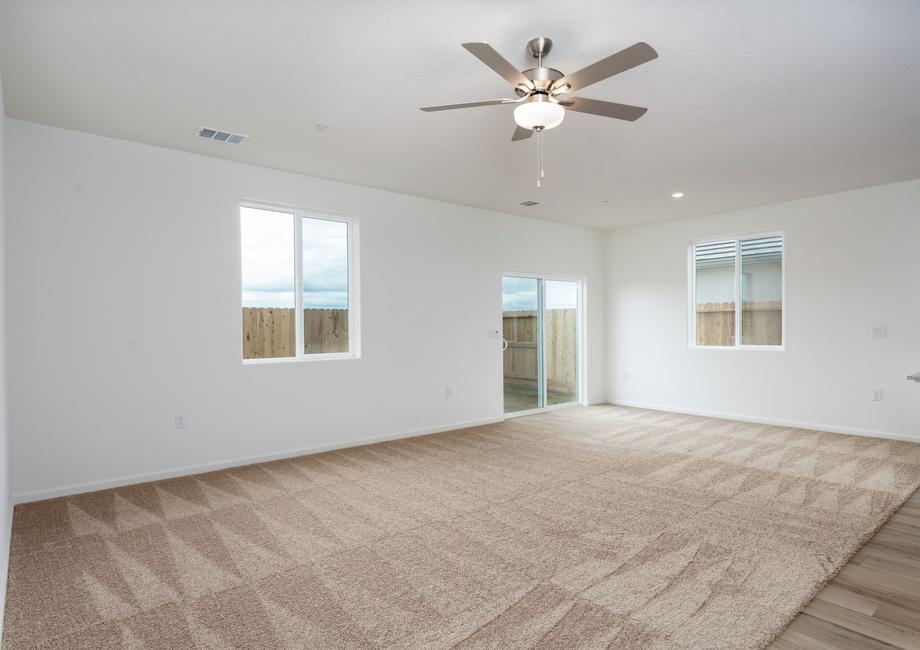 The family room is spacious and has a ceiling fan.