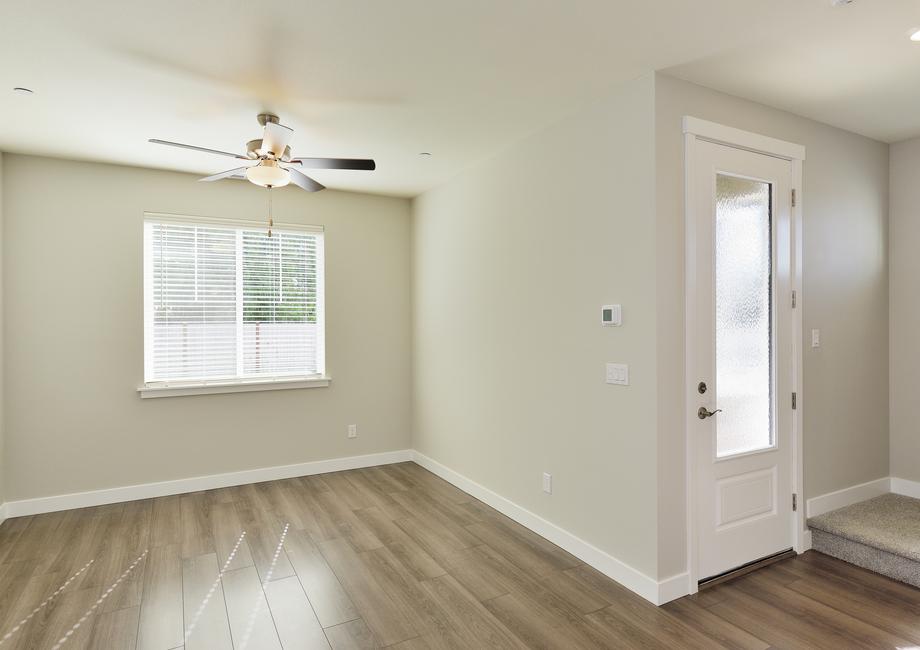 The family room is spacious with a ceiling fan.