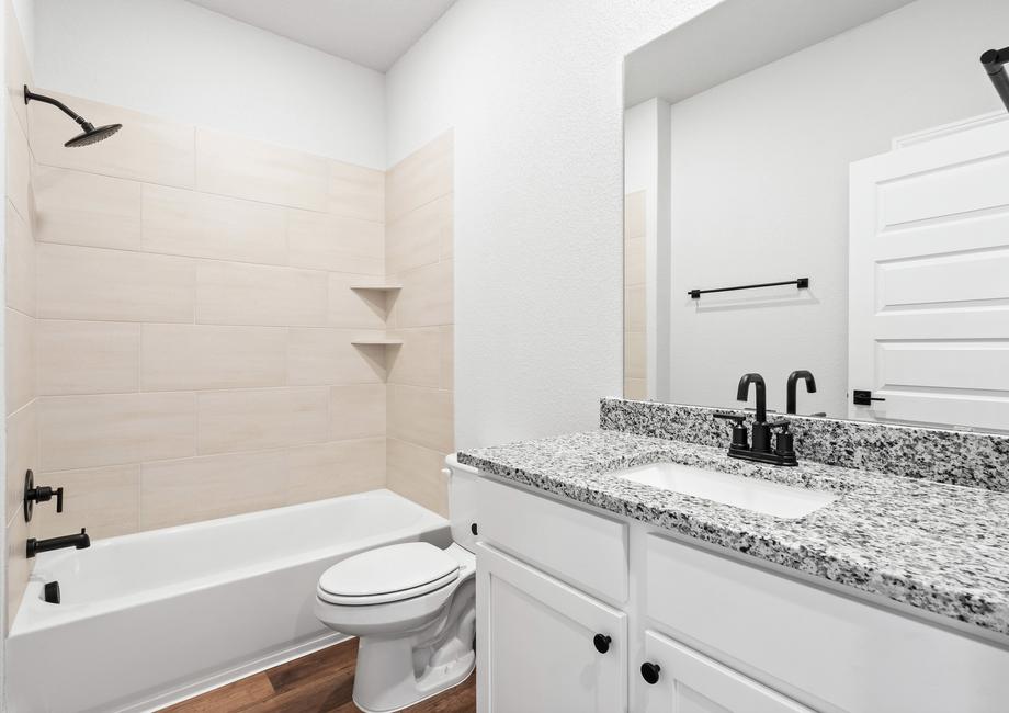 Secondary bathroom including designer features built throughout the home.