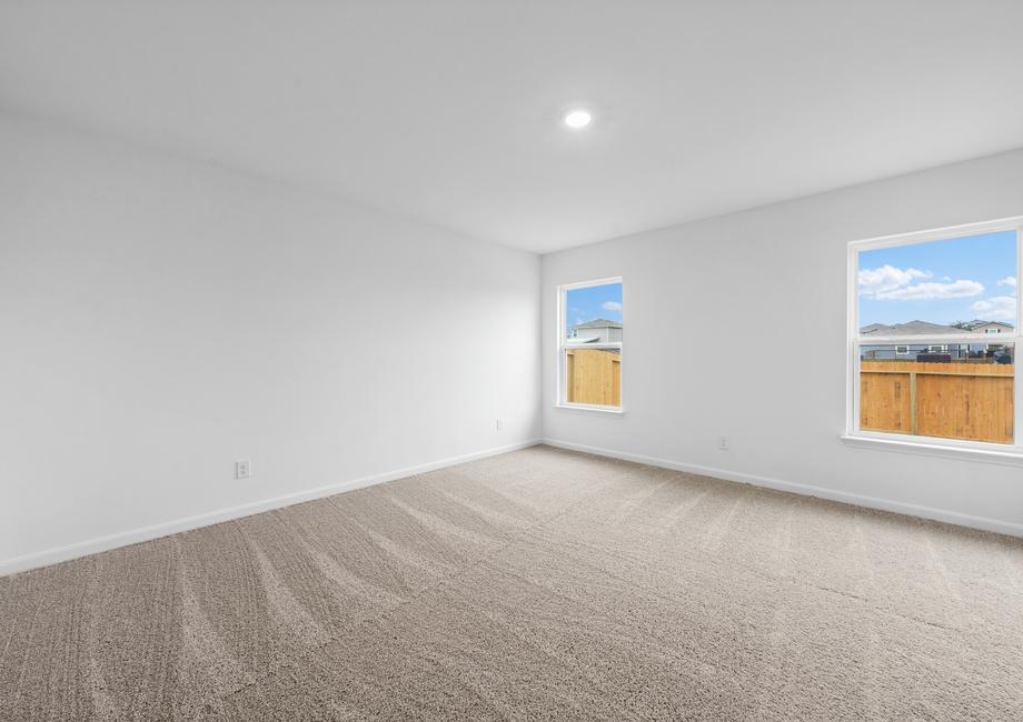 The master bedroom has two windows with a backyard view