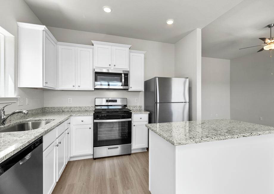 Granite countertops and stainless steel appliances fill the kitchen