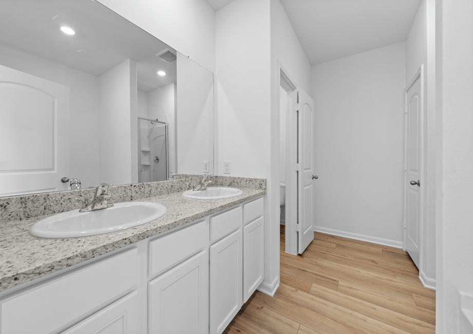 The master bathroom has two sinks and plenty of storage