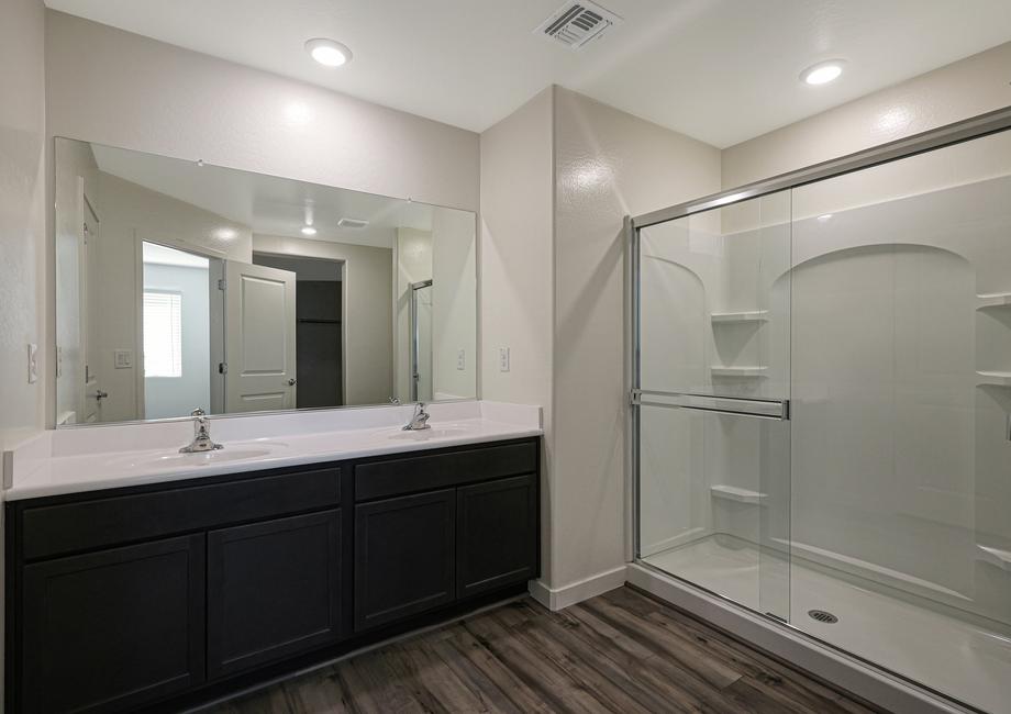 The master bath has a spacious, glass-enclosed shower.