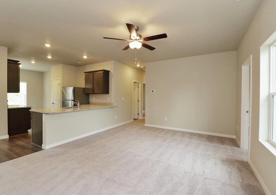 The family room is spacious and has a ceiling fan.