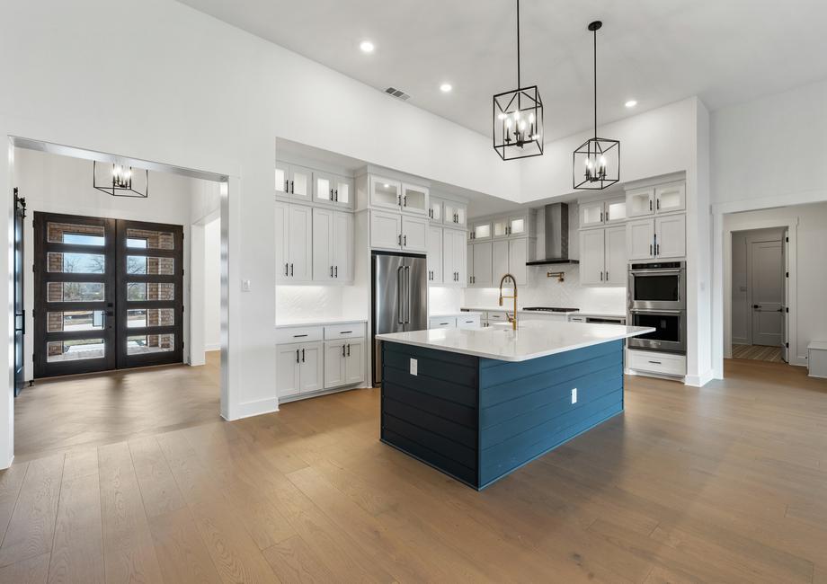 The kitchen has gorgeous white cabinetry with black hardware.