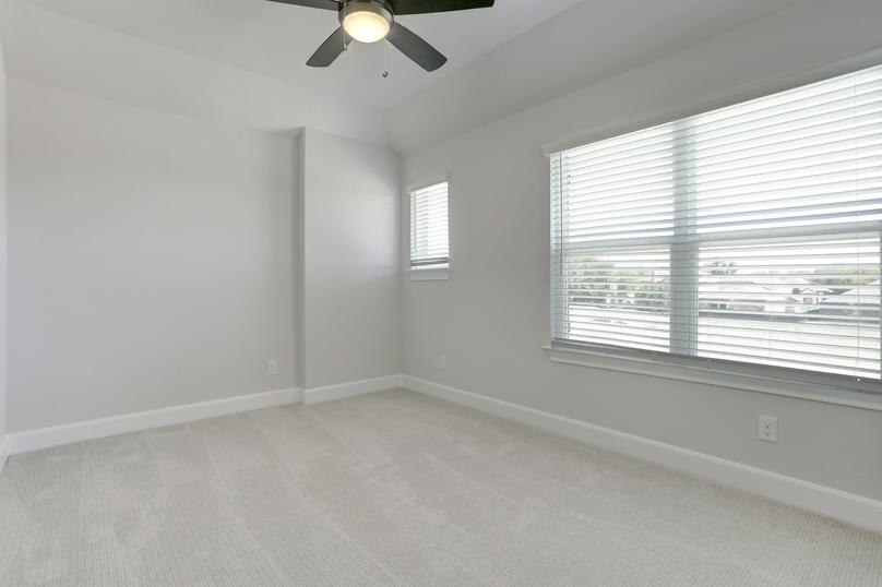 Secondary bedroom with large windows.