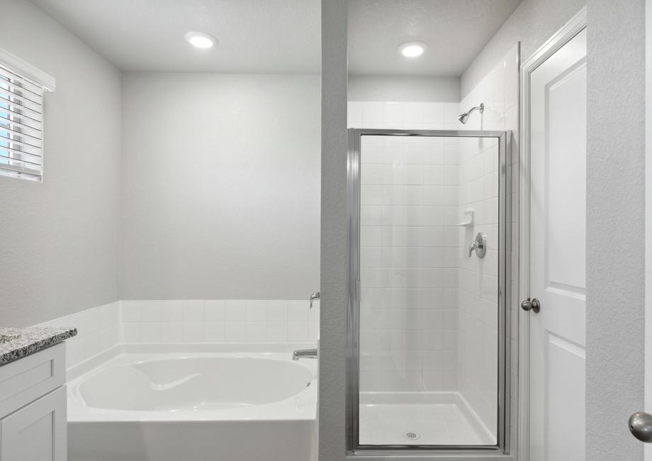 The master bathroom of the Platte has a garden tub and walk-in glass shower.