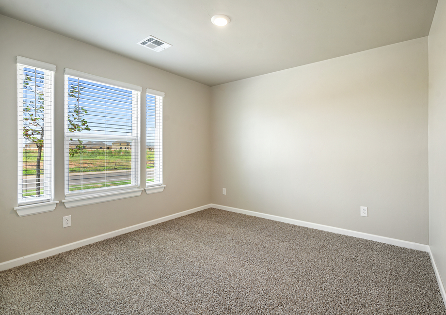 This bedroom has a beautiful large window letting natural light fill the space.