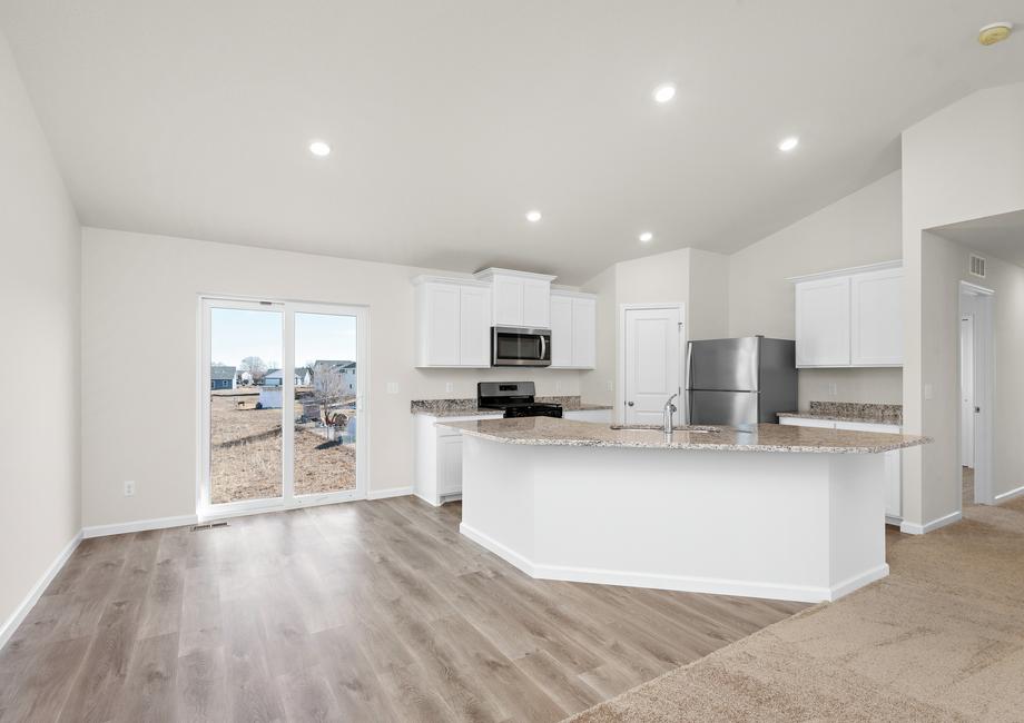 The kitchen has stainless steel applainces and plank flooring.