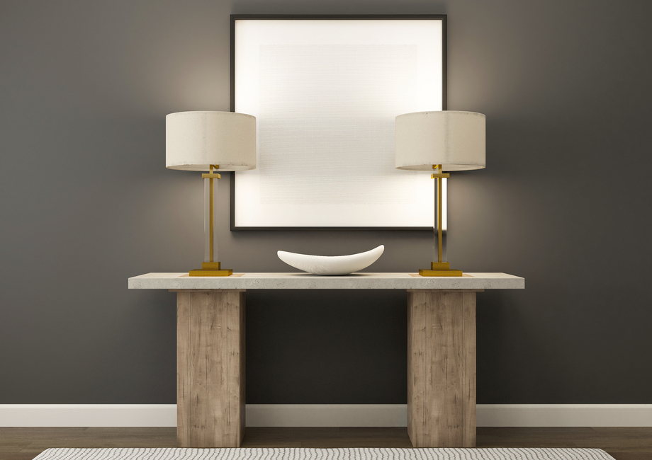 Rendering of foyer decorated with a table and decorative lamps.