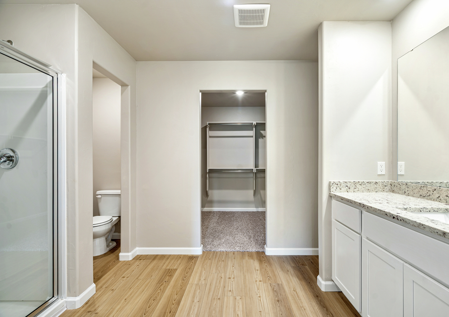 The master bathroom features a glass-enclosed shower and tons of closet space.