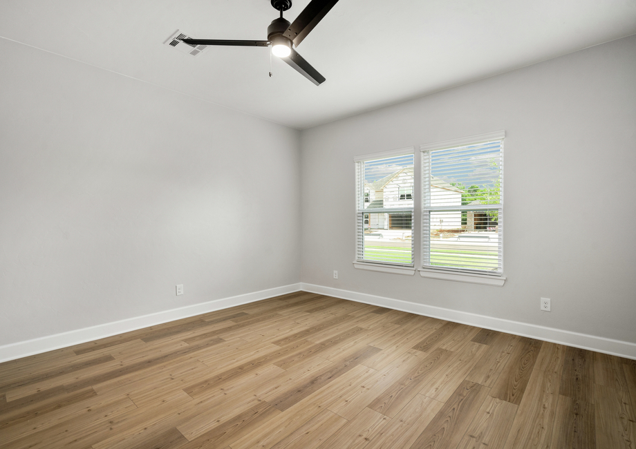 The master bedroom is spacious and has a wonderful window that lets in great, natural light.